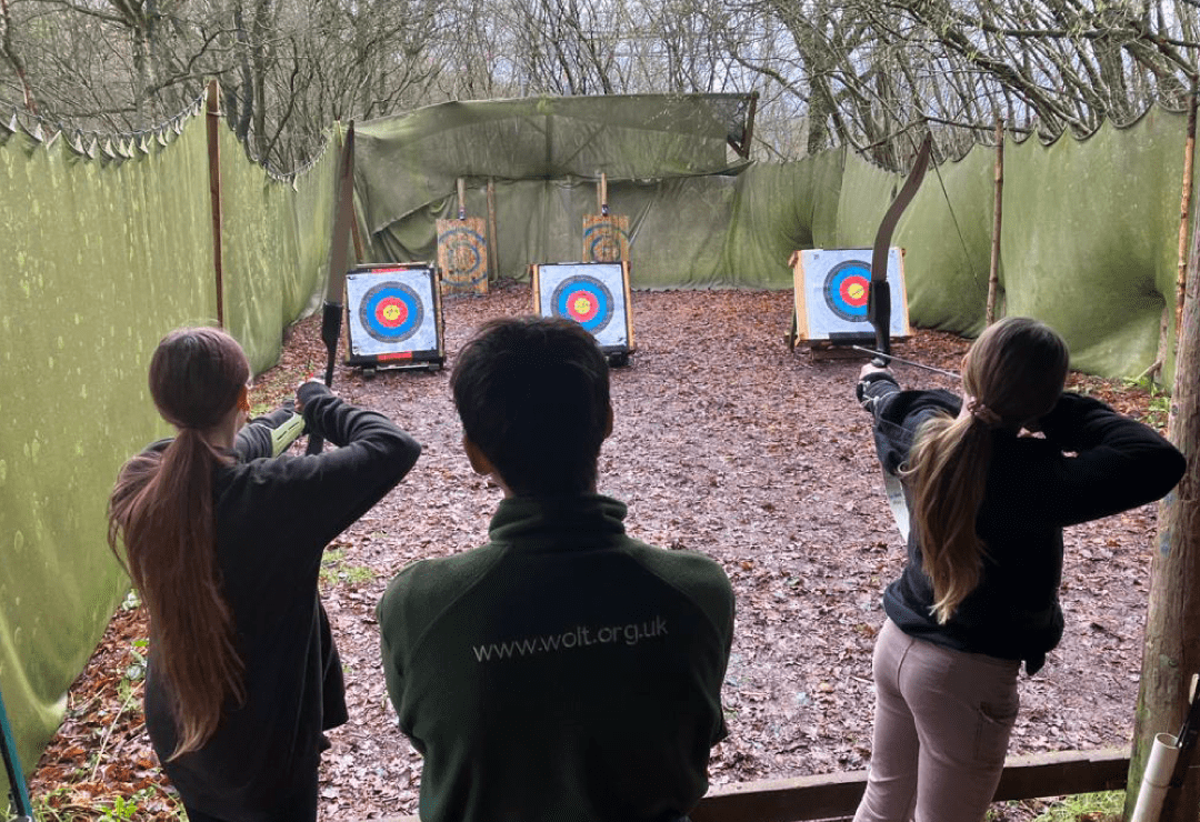 Young people take part in an archery activity with Splash